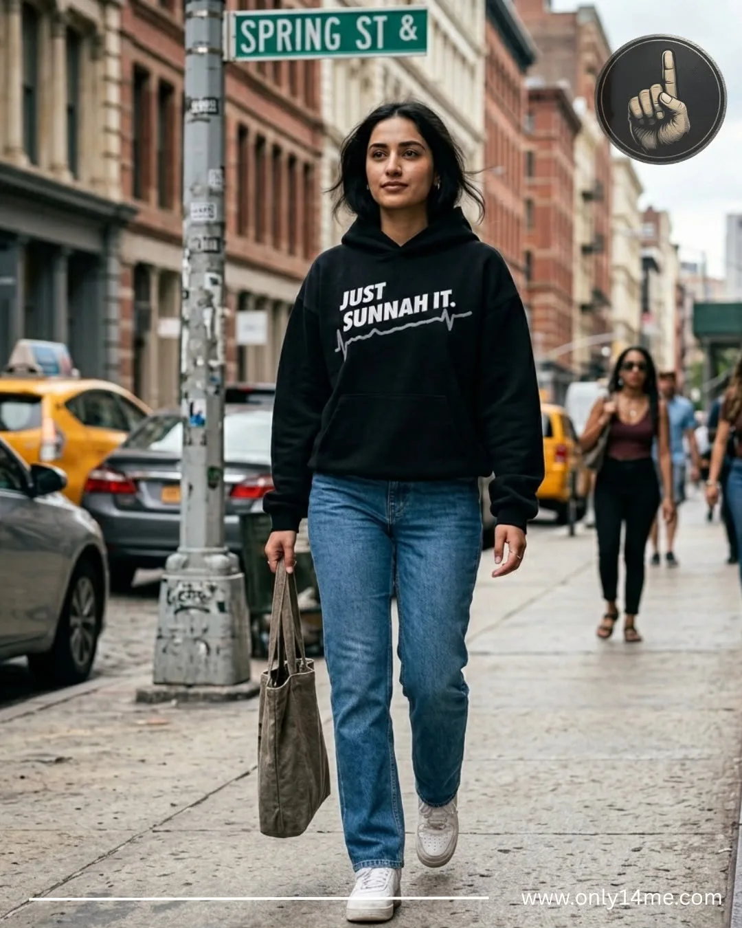 Model on Spring Street in the black Just Sunnah It hoodie with silver graphic
