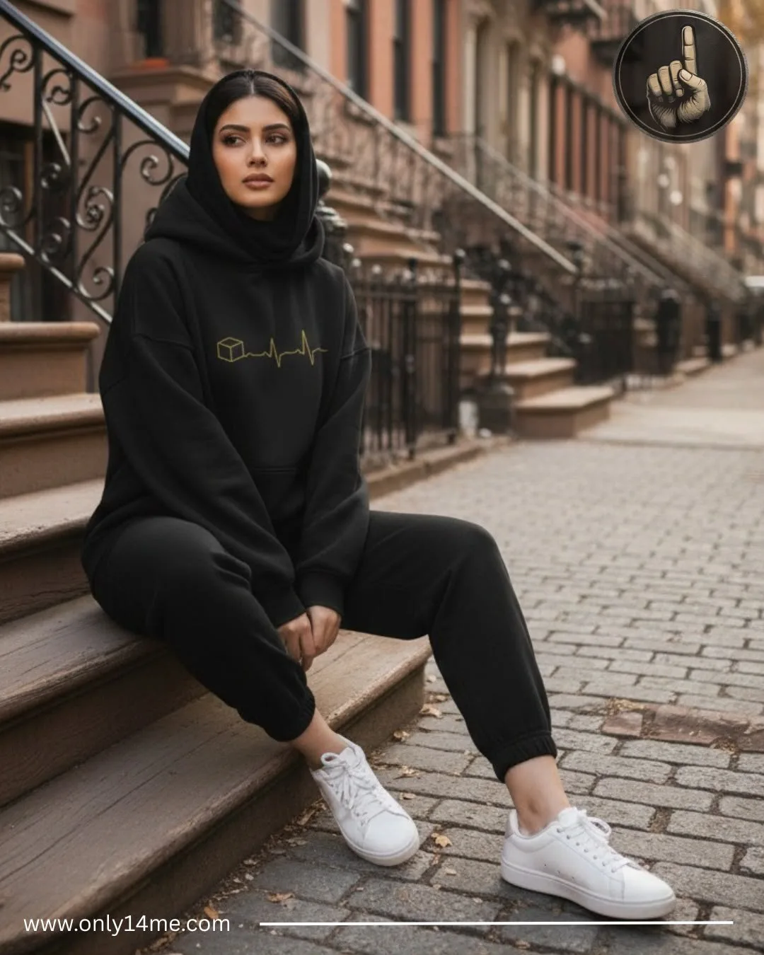 Black hoodie photographed on an urban stoop
